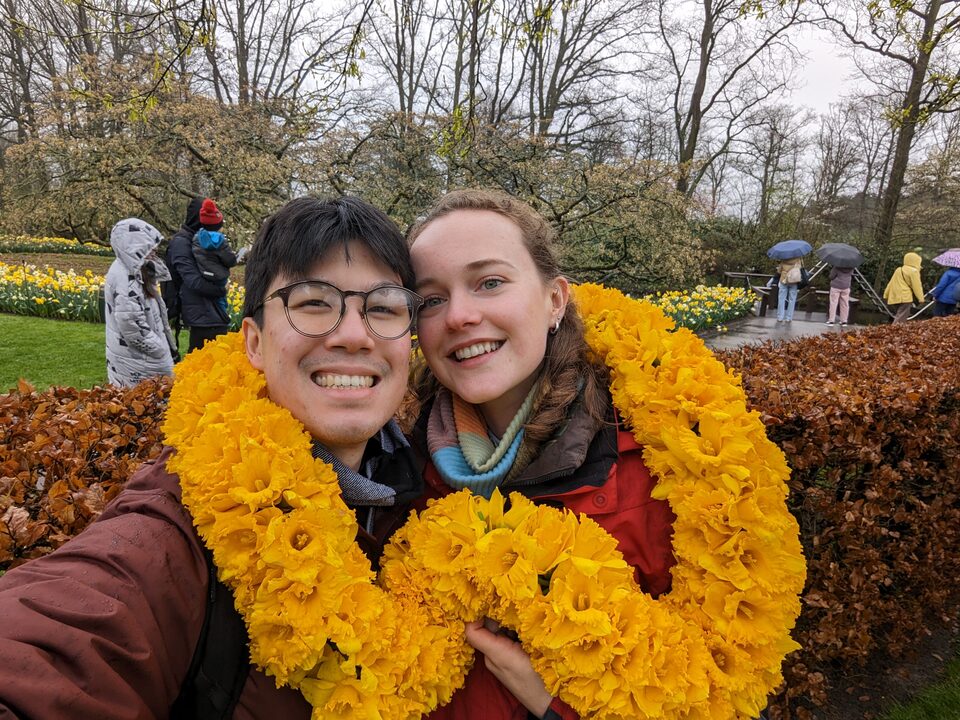 Andrew and Becky wearing a flower wreath.